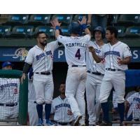 Mike Montville receives congratulations from his Rockland Boulders teammates following his home run