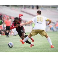 Ottawa Fury FC race to the ball vs. Louisville City FC