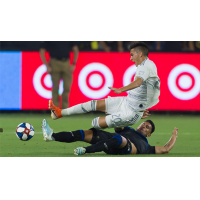 Andres Rios of the San Jose Earthquakes (bottom) makes a tackle against LAFC