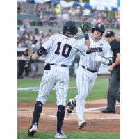 Josh Breaux of the Somerset Patriots gets a high five after his home run